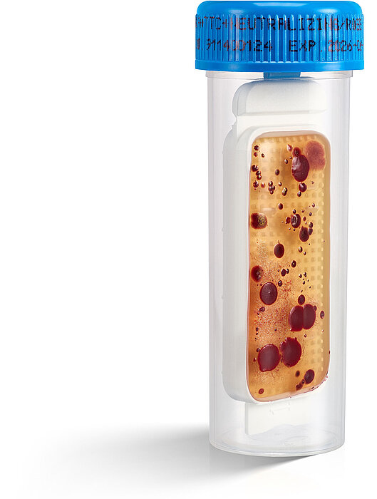 A dipslide culture method for monitoring microbial contaminations on a white background.